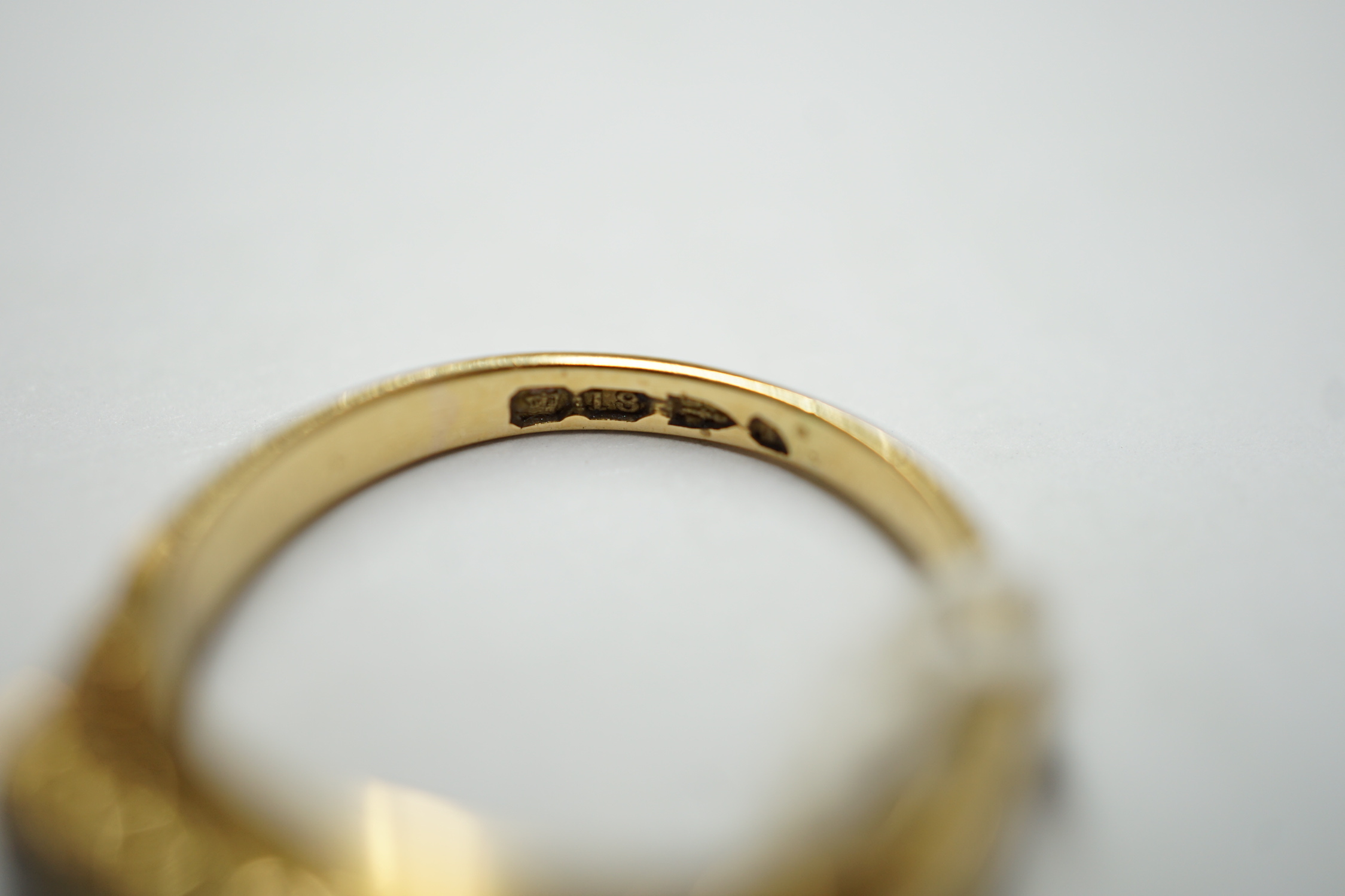 A late Victorian 18ct gold and three stone sapphire set ring, with four stone diamond set spacers, size M, gross weight 4.1 grams.